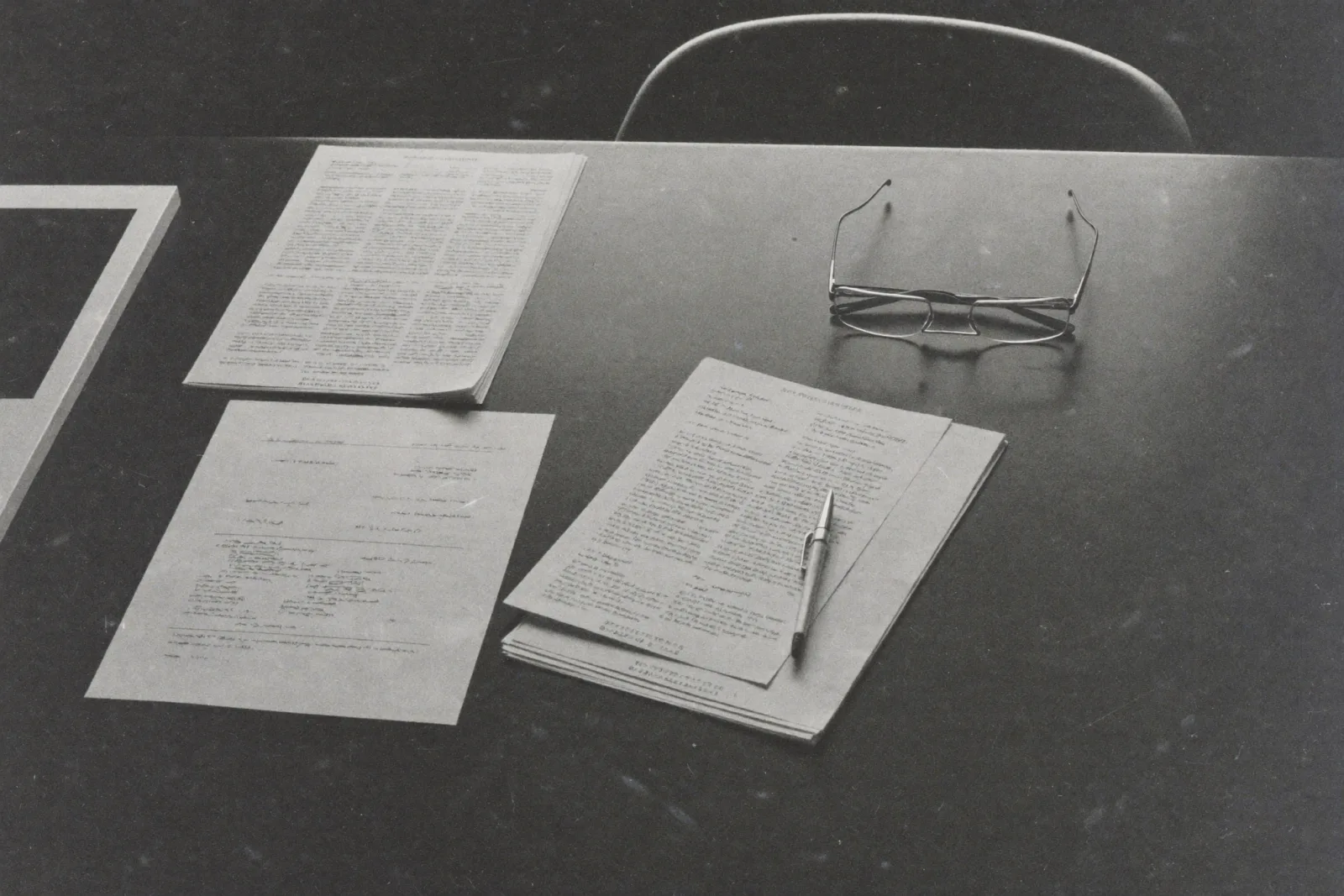 Annotated documents and charts on a desk